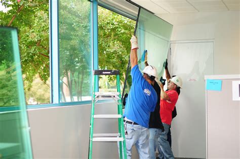 An image depicting commercial glass contractors doing glass repair